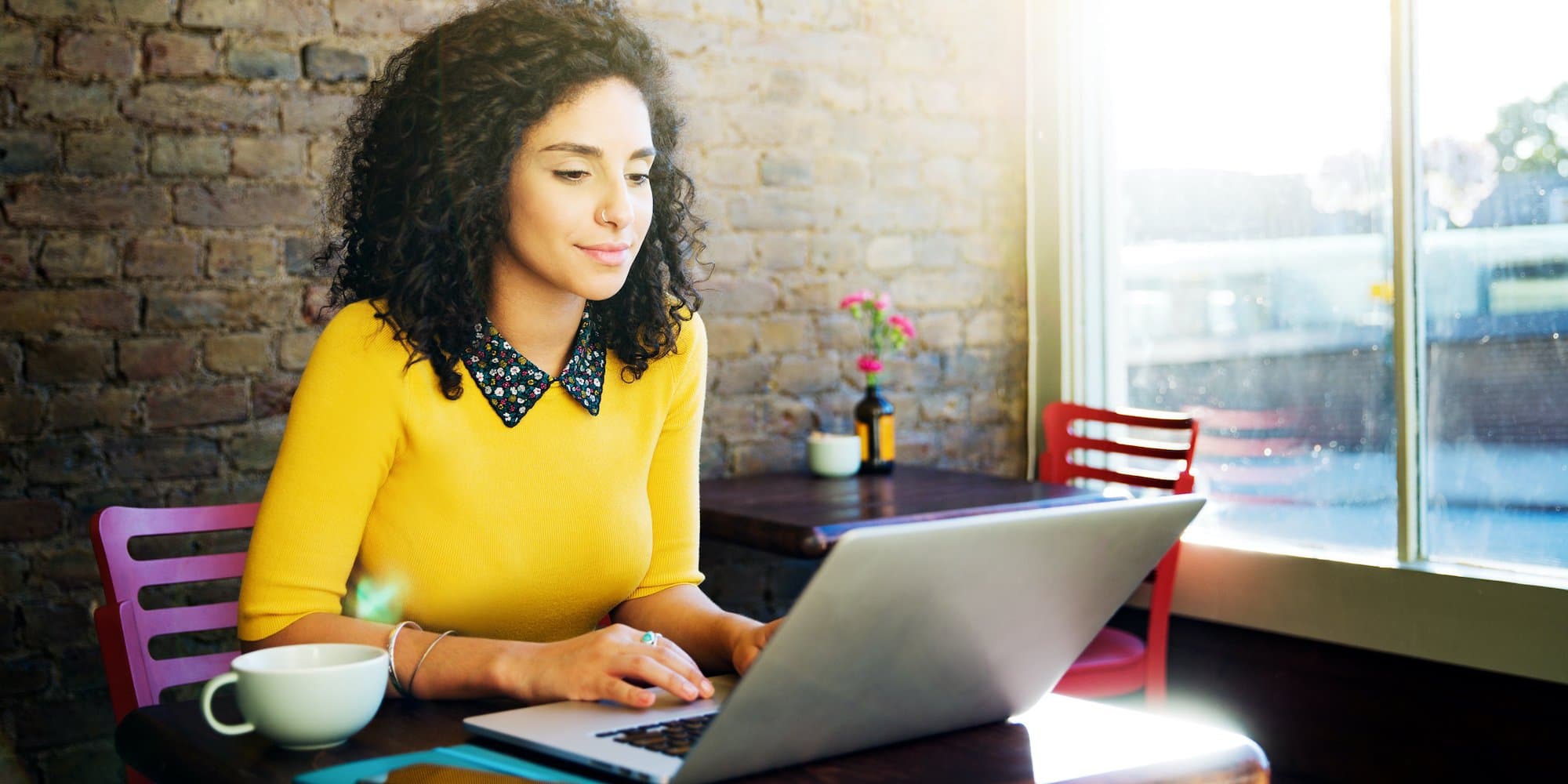 person working on laptop in cafe